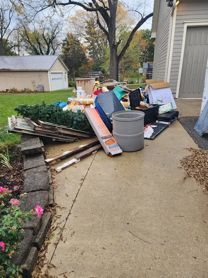 Dumpster being loaded with debris for Demolition Dumpster Rental in Stillwater